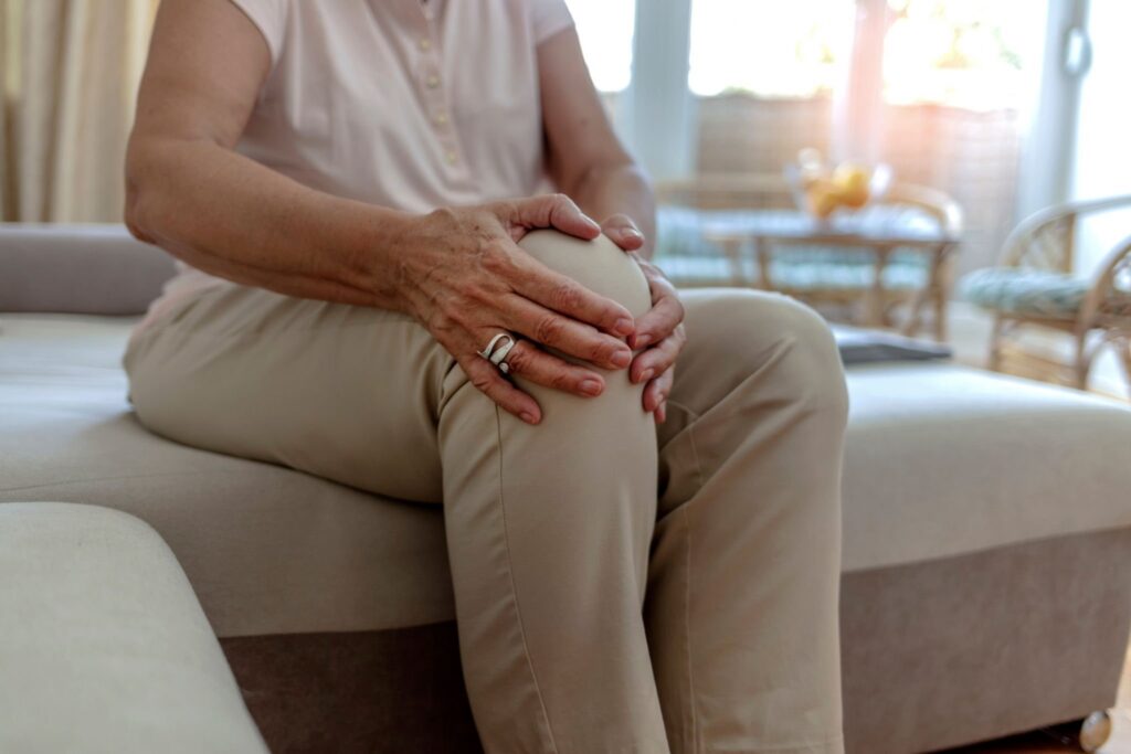 Women holding sore knee